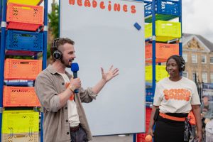 People with headphones talking into a microphone