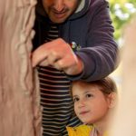 Child and father building a clay structure