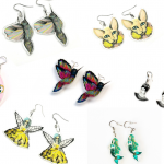 A collection of cat, butterfly, angel, fish and bird earrings