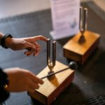 Hand tapping a metal sick on tuning forks